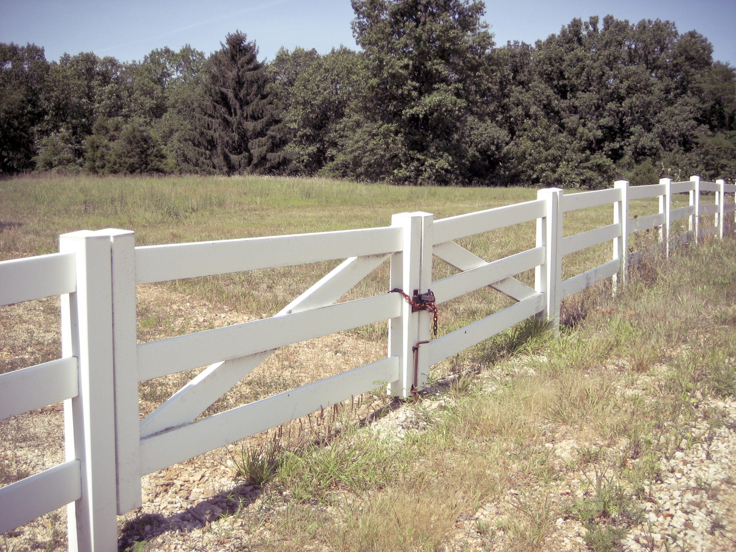 White rural fencing beside a property gate